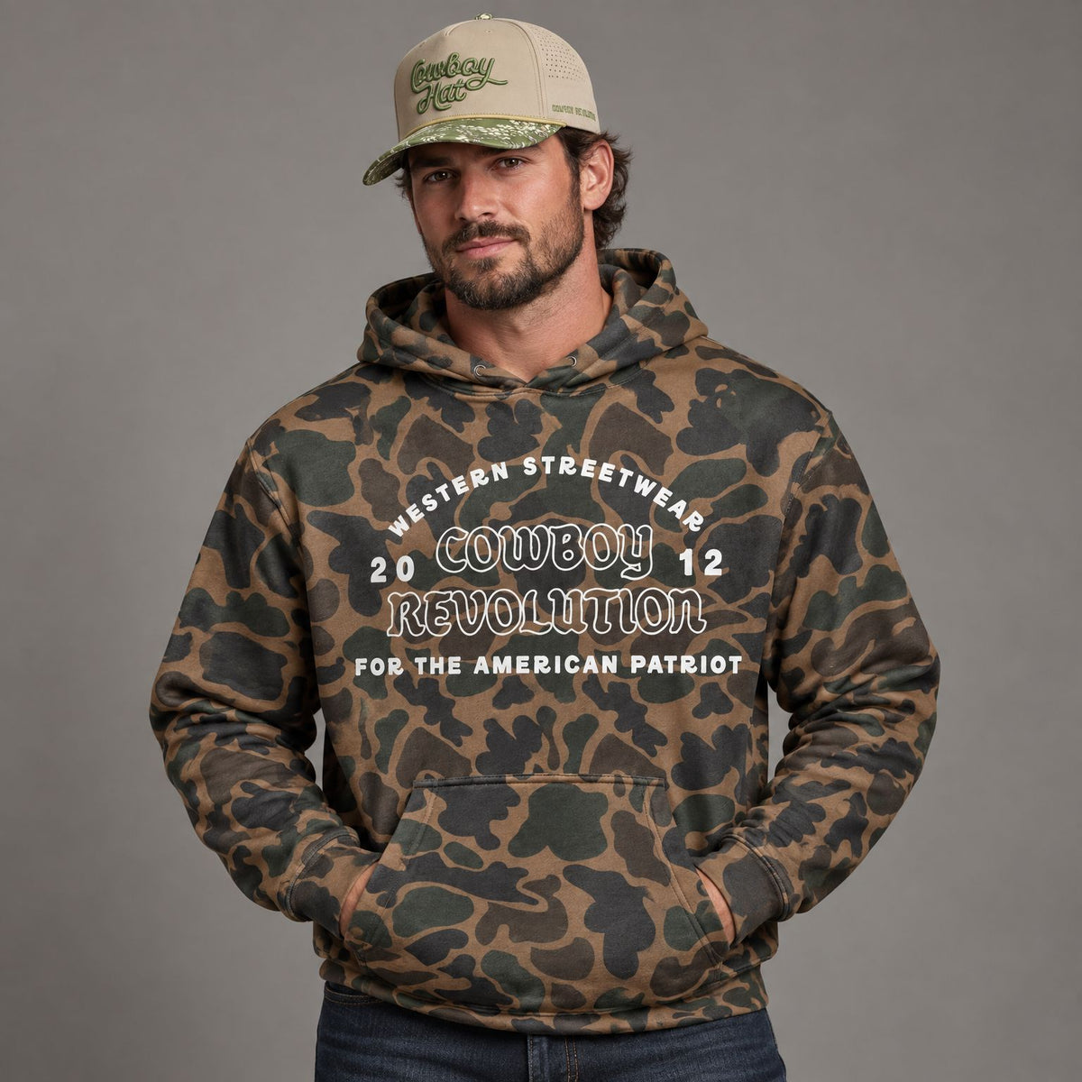 Western Streetwear Logo Camo Heavyweight Hoodie worn by male model in studio, with Cowboy Revolution Viper Duck Cowboy Hat