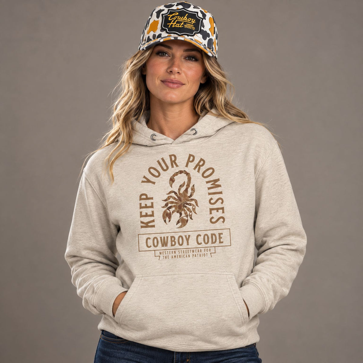 Cowboy Code #6 Promises hoodie worn by female model in studio, with Cowboy Revolution Viper NOLA White Cowboy Hat