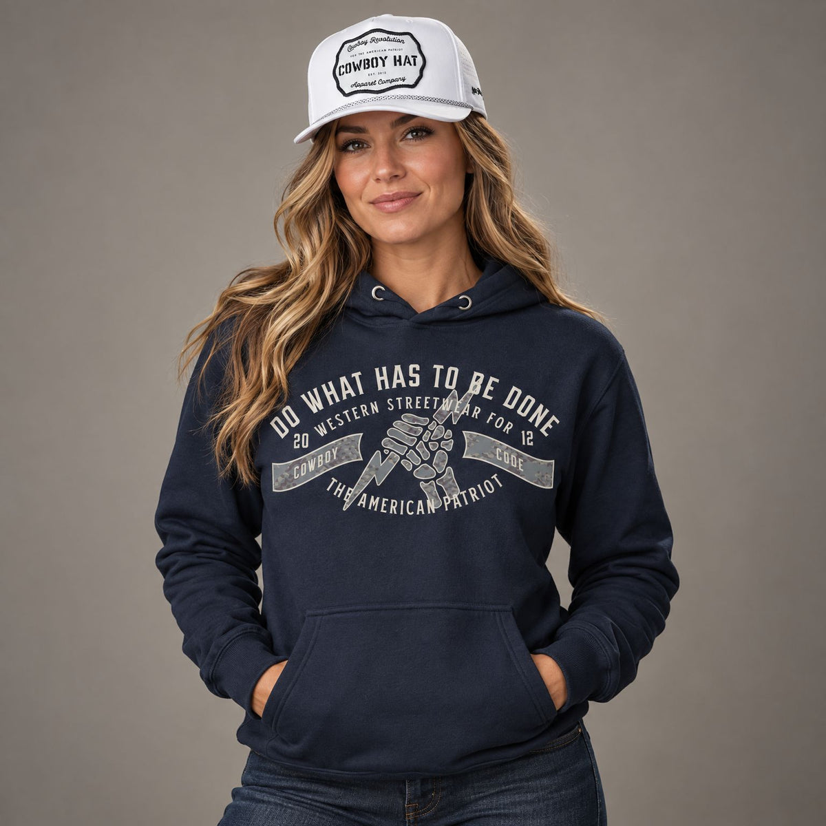 Cowboy Code #4 Get It Done hoodie worn by female model in studio, with Cowboy Revolution white Cowboy Hat Performance Patch Rope Hat