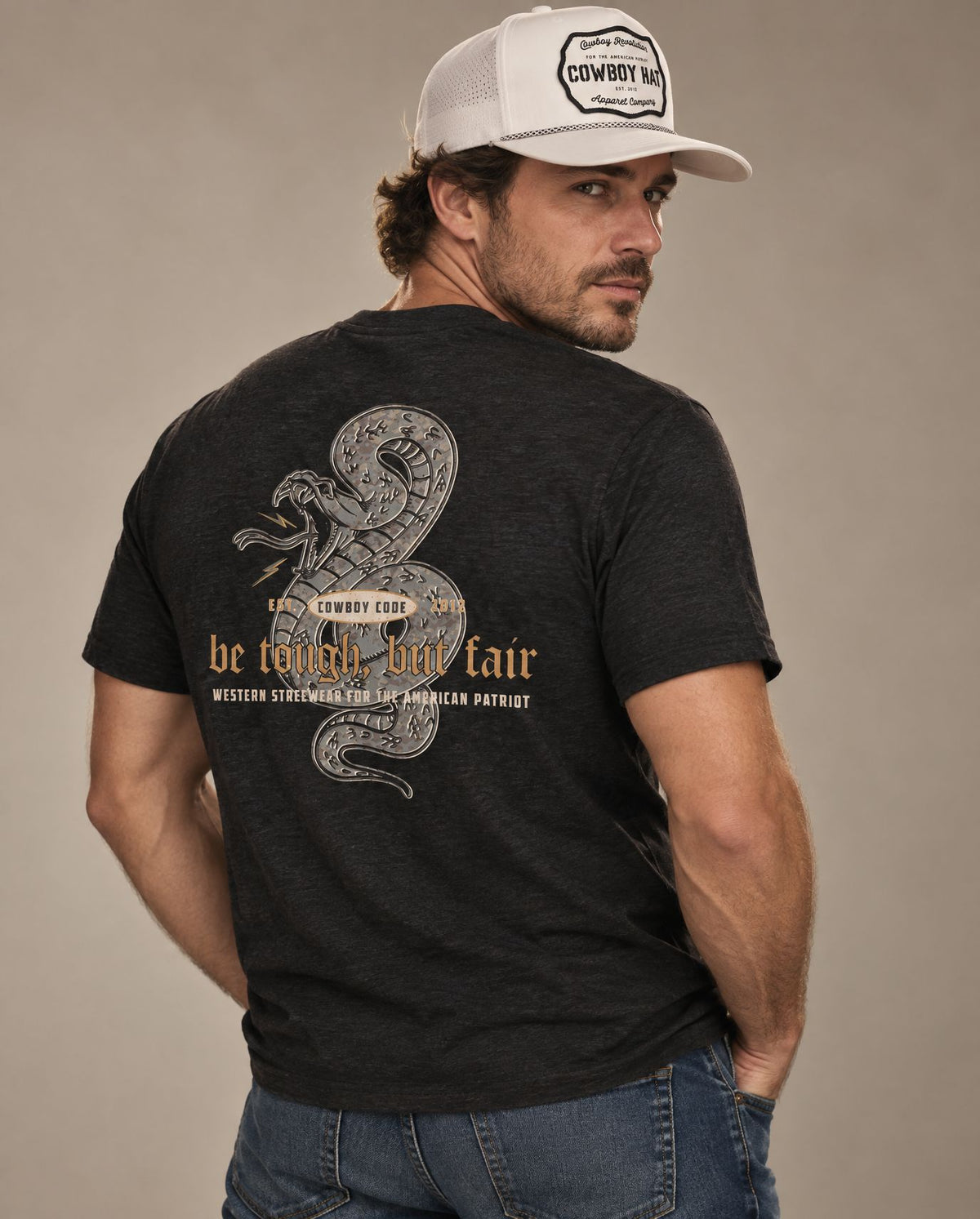 Male model in Cowboy Code #5 Be Tough, But Fair tee, Charcoal-Black and White rope hat, Cowboy Revolution