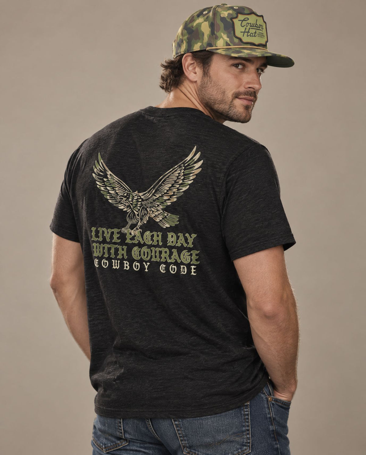 Male model in Cowboy Code #1 Live Each Day With Courage tee, Charcoal-Black and Woodland Camo rope hat, Cowboy Revolution