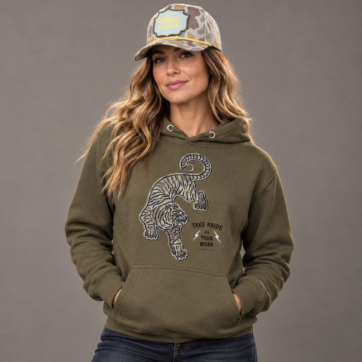 Cowboy Code #2 Work hoodie worn by female model in studio, with Cowboy Revolution Viper Marshland Cowboy Hat