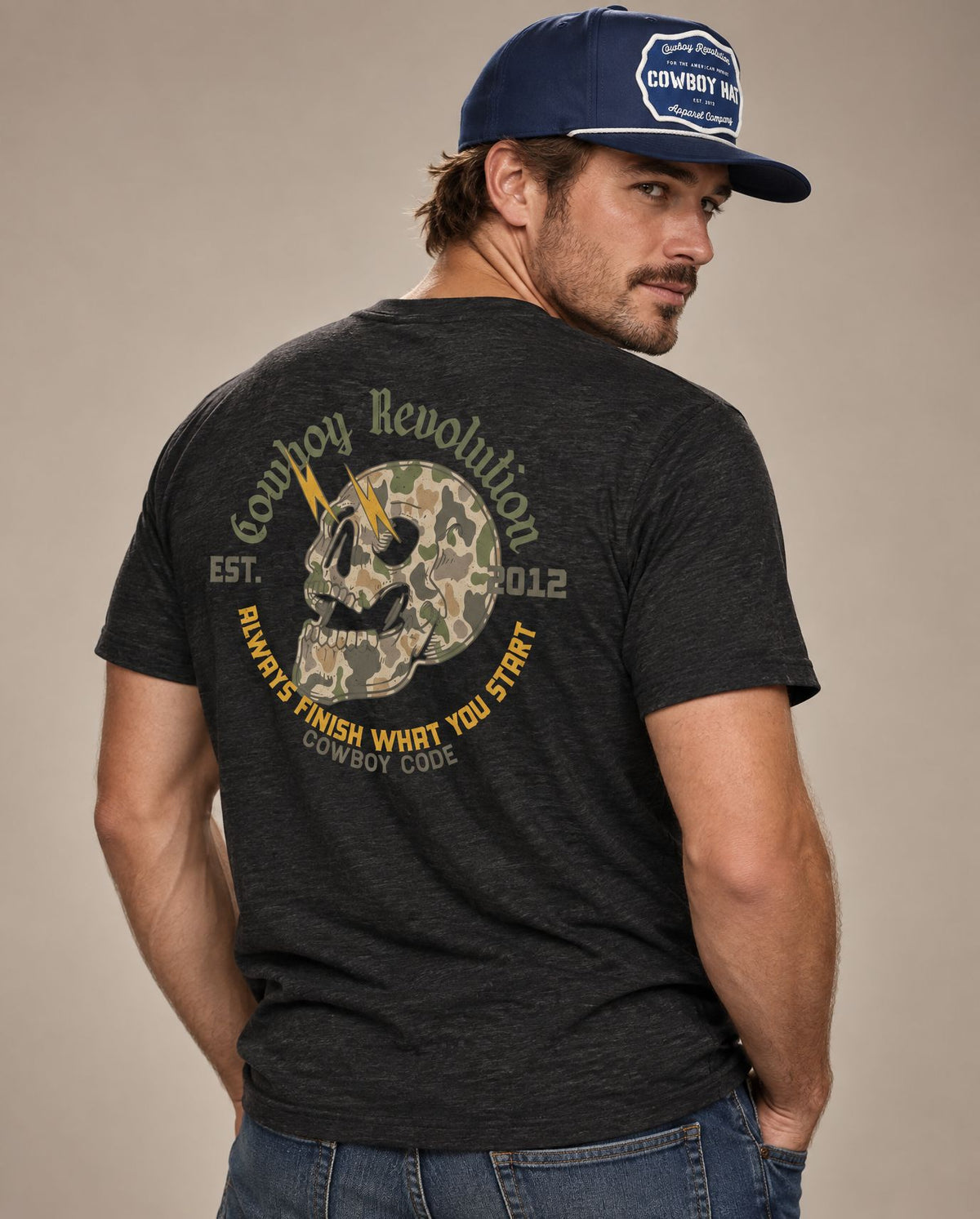 Male model in Cowboy Code No. 3 Always Finish What You Start tee, Charcoal-Black and Navy rope hat, Cowboy Revolution
