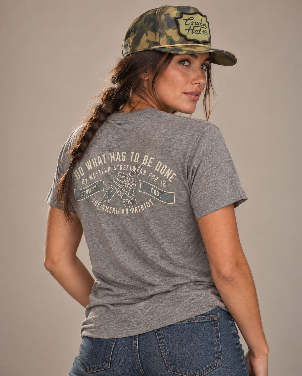 Female model in Cowboy Code #4 Do What Has to Be Done tee, Grey and Woodland Camo rope hat, Cowboy Revolution