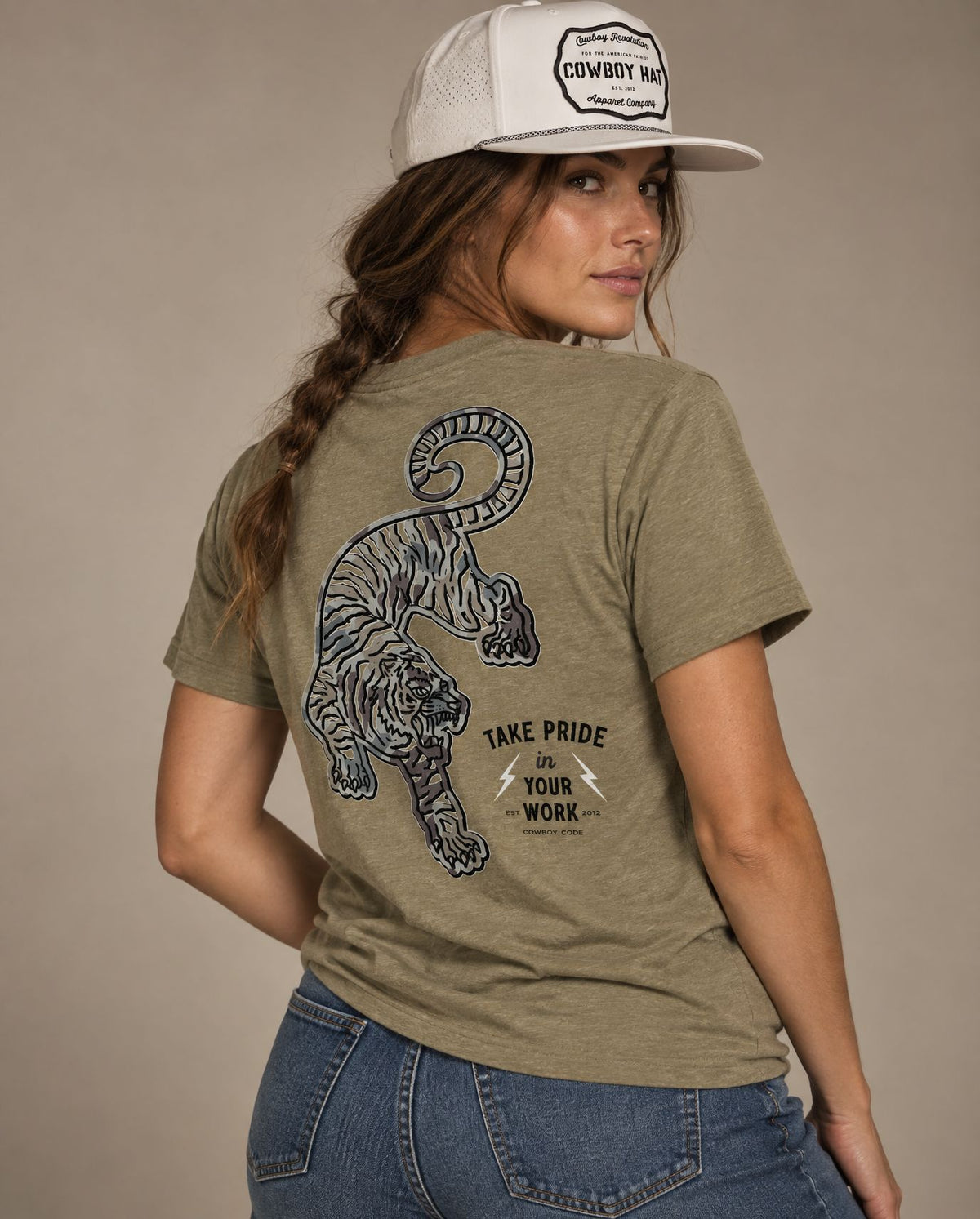 Female model in Cowboy Code #2 Take Pride in Your Work tee, Olive and White rope hat, Cowboy Revolution